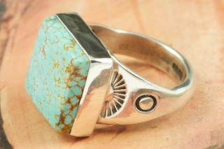 Genuine Number 8 Turquoise set in Sterling Silver Ring. The Number 8 mine is located in Eureka County Nevada. Since 1976 there has been no Number 8 Turquoise mined. There is however, an existing stock pile that Mr. Dowell Ward, the last owner of the Number 8 mine, had stocked away for later sorting. The Turquoise is a collector's item--because once the reserve is gone there will be no more material released onto the market. The Gold Mining Company owns the claim to the Number 8 mine and it has been swallowed up by the gold mining operations. This is some of the last Number 8 Turquoise to be had and will be a great addition to your collection. Created by Navajo Artist Phillip Sanchez. 